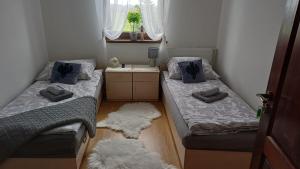 a small room with two beds and a rug at Pokoje u Kasi i Marcina in Lipnica Wielka +71 photos