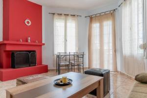 a living room with red walls and a fireplace at Danai & Palm Stay Complex by Horizon Homes in Ofrínion