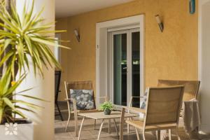 a group of chairs and a table on a patio at Villa Esplendida by Abahana Villas in Ifach
