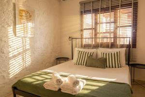 a bedroom with a bed with towels on it at Helios stone house in Aegina