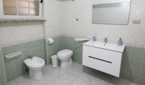 a bathroom with a toilet and a sink at Helios Rooms in Quartu SantʼElena