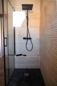 a bathroom with a shower with a shower head at Azure méditerranée in Sérignan +33 photos
