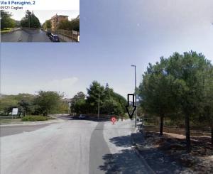 an empty street with trees and a red fire hydrant at Il Perugino in Cagliari