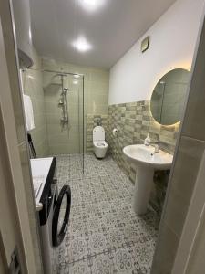 a bathroom with a toilet and a sink and a mirror at Duplex Hause in Telavi +17 photos