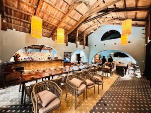 a dining room with a long table and chairs at Cabalina Grove in Ðảo Cát Bà