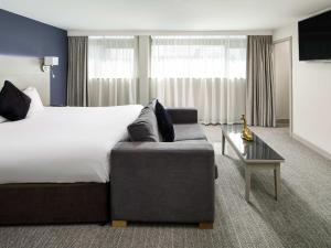 a hotel room with a bed and a couch at Mercure Manchester Piccadilly Hotel in Manchester +82 photos