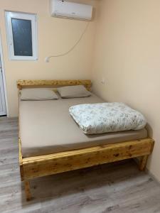 a bedroom with a wooden bed in a room at Comfort in Reni +13 photos