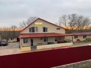 a building with a red fence in front of it at Comfort in Reni