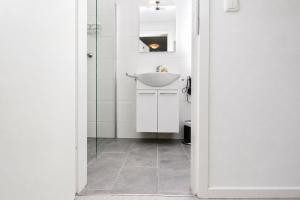 a bathroom with a sink and a mirror at Kirchenplatz 6 Apartment 18 Atlantic in Warnemünde +9 photos