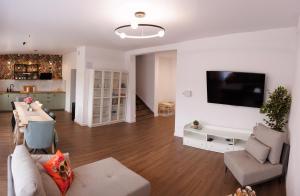 a living room with a couch and a tv on a wall at Akacjowa 11 in Skorochow