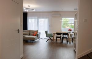 a living room with a couch and a table and chairs at Akacjowa 11 in Skorochow