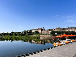 a row of boats with umbrellas next to a river at triDOMESFRANCE in Saverne +21 photos