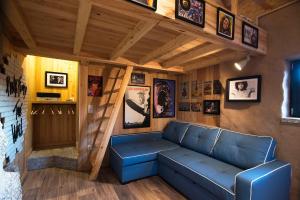 a living room with a blue couch in a house at Welcome to Gerês in Ventosa
