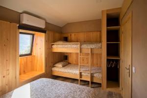 a small room with bunk beds and a window at Welcome to Gerês in Ventosa +39 photos