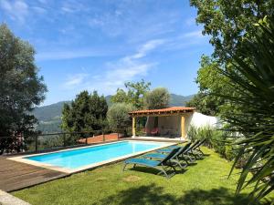 a swimming pool in the yard of a house at Welcome to Gerês in Ventosa