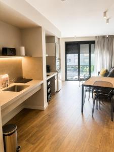 a kitchen and living room with a table and a dining room at Apartaments Turístics Conseller in Andorra la Vella