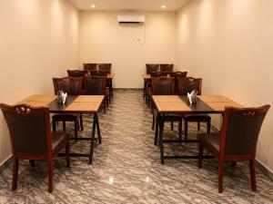 a conference room with wooden tables and chairs at Goa Villagio Hideaway in Majorda