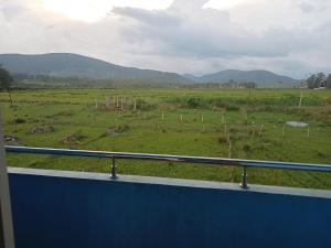 a view of a field from a train window at mythriinn in Araku