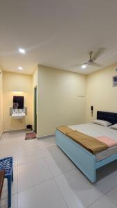 a bedroom with a bed and a tv on a wall at Gravity Groups Core VHR Residency in Puducherry Airpoert +20 photos