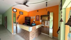 a woman sitting at a bar in a restaurant at Gravity Groups Core VHR Residency in Puducherry Airpoert