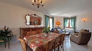 a dining room with a table and a living room at Le gîte de montréal in Saint-Germain-les-Belles
