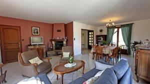 a living room with a couch and a dining room at Le gîte de montréal in Saint-Germain-les-Belles