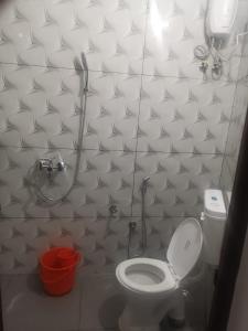 a small bathroom with a toilet and a shower at Railviewtouristhome in Varkala
