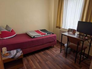 a small room with a bed and a desk at Stadt Hamburg in Lenzen