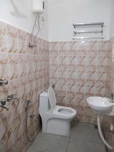 a bathroom with a toilet and a sink at Kasi Heritage Home Near Sree Padmanabha Swami Temple 800m in Trivandrum +40 photos