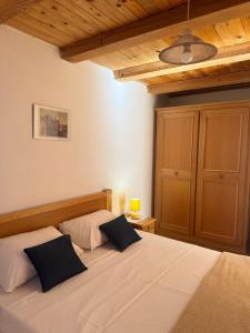 a bedroom with a bed with two pillows on it at Ducina Apartments in Milna