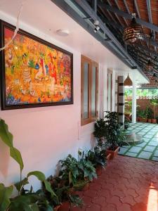 a large painting on the wall of a building with plants at Kasi Heritage Home Near Sree Padmanabha Swami Temple 800m in Trivandrum