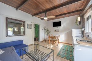 a living room with a blue couch and a table at Sunwaves 4 - Casa Duna in El Palmar