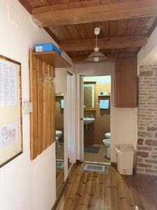 a hallway with a bathroom with a toilet and a ceiling at Ducina Apartments in Milna