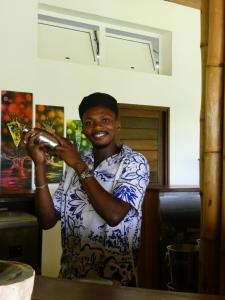 a man is smiling while holding a glass at Belamandy Lodge Hotel au luxe simple in Anjramarango