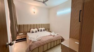a bedroom with a bed with white flowers on it at Krishna Cottage 3BR Apt By Amoret Homes in Chicalim +13 photos