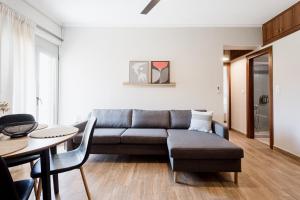 a living room with a couch and a table at NIMA Mytikas Apartments - Aitoloakarnania in Mitika