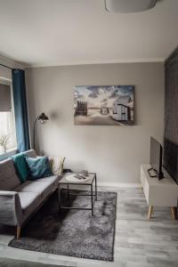 a living room with a couch and a table at Apartment Nr 06 in Bremerhaven