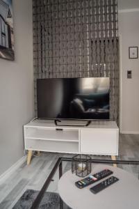 a living room with a tv on a white entertainment center at Apartment Nr 06 in Bremerhaven +2 photos