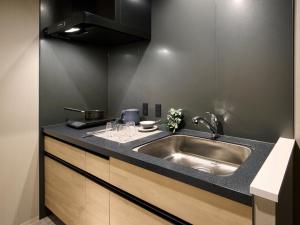 a kitchen with a sink and a counter top at Minn Sapporo Odori W14 in Sapporo