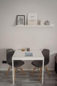 a white table with two chairs in a room at Apartment Nr 06 in Bremerhaven
