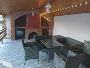 a living room with a fireplace and a table and chairs at APARTMAN BUKULJA 2 in Arandelovac