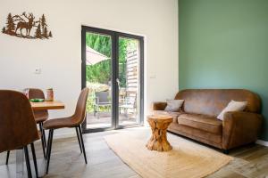 a living room with a couch and a table at Flora Gîte in Kaysersberg