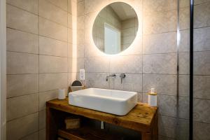 a bathroom with a white sink and a mirror at Flora Gîte in Kaysersberg +18 photos