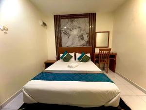 a hotel room with a bed and a desk at Near Jonker Street - JCITYHOTEL - FREE PARKING in Malacca