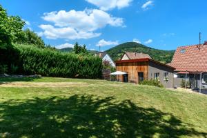 a view of a house and a grassy yard at Flora Gîte in Kaysersberg