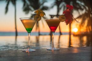 two cocktails sitting on a table near the ocean at Belamandy Lodge Hotel au luxe simple in Anjramarango +60 photos