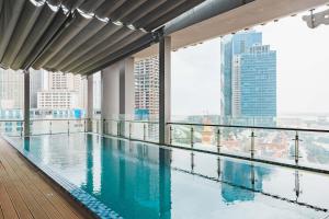 a swimming pool on the roof of a building with a view at Diamond Pearl Hotel ,Phnom Penh,Royel Palace, Mekong RIver,Swimming Pool in Phnom Penh