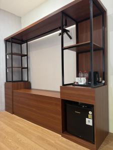 a room with a counter with a microwave and a shelf at And Living Hotel in Kejayan