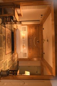 a view of a bathroom with wooden walls and a mirror at Kainchi Boutique Homestay in Rāmgarh +7 photos