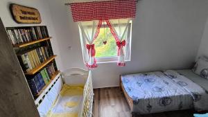 a bedroom with a bed and a window at Vujanac vikend kuća in Raška +49 photos